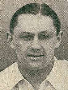 Headshot of a man in a white shirt