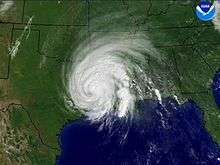 Satellite image of a tropical cyclone with a well-defined spiral organization but no eye