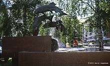 A bronze fountain depicting three salmon jumping up a river