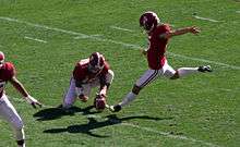 American football placekicker about to kick a football.