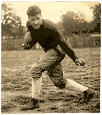 Guyon in his Tech uniform, posing in a running stance with a football