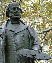 Photo of Statue of John Ericsson in the Battery, New York City, holding a model of Monitor in his hand