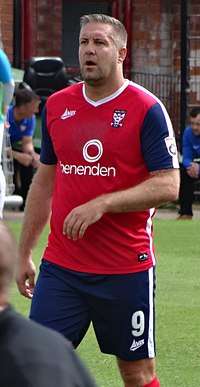 Jon Parkin standing on a grass field