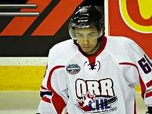 Young man wearing hockey jersey and helmet