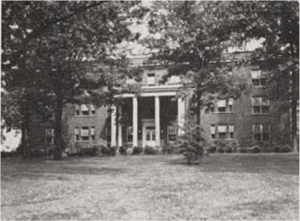 A brick, neoclassical hospital building.