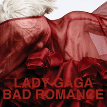 Upper bust of a blond woman. She has short cropped hair. Her body and her face is covered by a red translucent cloth with intricate wrappings in the front. Over the image the words "Lady Gaga" and "Bad Romance" are written in red capital letters.