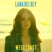 A yellow-filtered portrait of a brunette woman wearing a denim jacket, standing on a beach with waves as her backdrop. In bold blue font above her is the name, Lana Del Rey. Below her in bold yellow font is the title "West Coast".