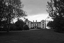 Exterior of quite large country house in extensive gardens