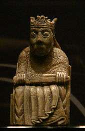 Photograph of an ivory gaming piece depicting a seated king