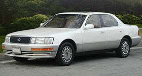 Front quarter view of a sedan parked on a street.