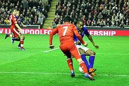 Luis Suárez in Liverpool kit clashes with Sylvian Distin in Everton kit.