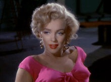  Monroe in Niagara. A close-up of her face and shoulders; she is wearing gold hoop earrings and a shocking pink top.