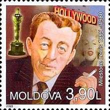 A stamp of an man holding a cigarette. Near him an Academy Award, a woman and some white capital letters are visible.