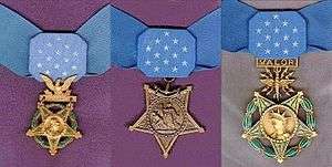 Three medals, side by side, consisting of an inverted 5-pointed star hanging from a light blue ribbon with 13 white stars in the center. Left medal has a laurel wreath around the star and an eagle emblem above the star; central medal has an anchor emblem attaching the medal to the ribbon; rightmost medal has a laurel wreath around the star and an emblem with wings, lightning bolts and the word "VALOR" connecting the medal to the ribbon.