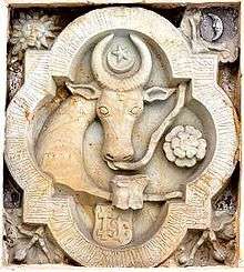 A coat of arms depicting the head of an aurochs with a crescent and a star over it