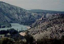 Lower Neretva Valley - pictured from behind the walls of Počitelj, looking upstream towards Počitelj village and its Citadel, and further behinde Mostar