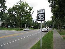 NY 65 and a shield in residential Honeoye Falls