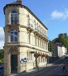 Italiante three story building, with narrow entrance at the end of the building nearest the camera