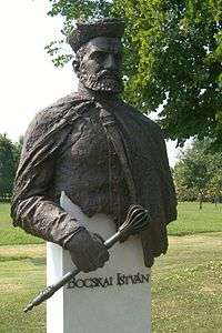 Statue of bearded man with hat, holding a scepter