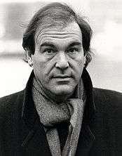 Black-and-white picture of Oliver Stone looking to the camera.