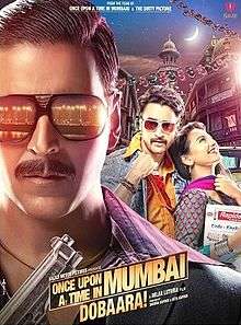 The bust of the title character, Shoaib Khan (Akshay Kumar) wearing black full frame sunglasses consisting the reflection from streetlights dotting the coast line of the city and a black suit and a purple and violet striped shirt underneath holding a gun in his hand occupies a significant portion of the poster, mostly left and lower-front. In this case the city being Mumbai, or Bombay as it was known in the period which the film is set in. The other male lead of the film is facing front wearing a denim jacket, saffron shirt and stylized sunglasses holding his shirt-collar up with a woman breaking into laughter resting on his chest looking upwards. The backdrop consists of verandahs of chawls of Mumbai and a waxing crescent moon in the sky. The title logo of the film and credits below.