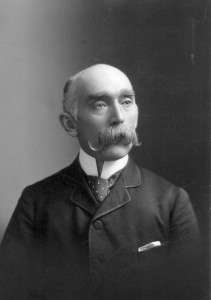 Portrait of chief medical officer Peter Bryce in 1890. Wearing a jacket and tie, he is looking off-camera with his face expressionless