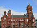 Victorian red brick building with clock tower to the right