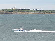 Small police boat on large body of water