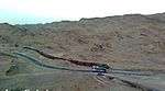 Photo of a train by a road.