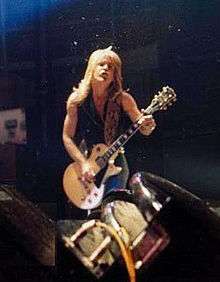 A guitar player performing heavy metal music in 1980