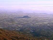 Rocca di Cavour standing out from the plain of the Po valley