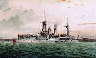 A light gray ship sits at anchor in a choppy green sea, black smoke drifting from two smoke stacks