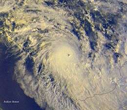 Satellite image of a powerful cyclone near the coast of Western Australia. The storm is relatively small but very mature, with a condensed area of deep thunderstorms and a well-defined, clear eye