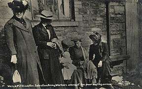 A female Salvation Army officer comforts a family