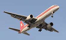 Front quarter view of twin-jet aircraft at takeoff, with extended gear.