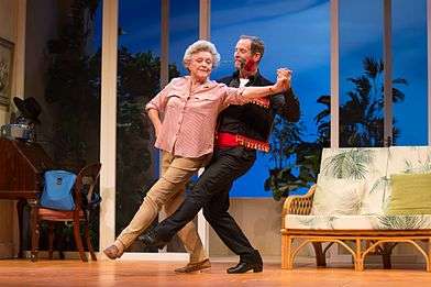 Todd McKenney (red rose in mouth) and Nancye Hayes dancing the tango in a performance of the play Six Dance Lessons in Six Weeks