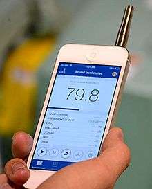 An image of a person holding a smartphone displaying the NIOSH sound level meter application (app)