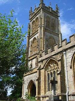 Stone building with arched windows and square tower.