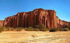 A red and vertical rock face.