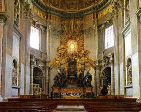 Pews before the ornate, gold-leafed throne of St. Peter