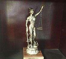 An imagine of a trophy awarded to a new member of the Order of the Barristers.  The trophy consists of a statute of Lady Justice.