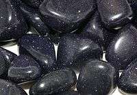 Tumble polished blue Goldstone pieces.