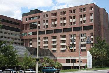 Photo depicts one wing of the J. Hillis Miller Health Science Center, a modern red brick complex that encompasses the University of Florida's teaching hospital and colleges of medicine, nursing, dentistry and pharmacy.