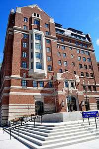 Red brick facade with white stone fronts and angled roof