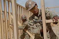 Camp Leatherneck, Afghanistan (13 May 2009) Navy Petty Officers 1st Class John Cid, from Quezon City, Philippines, and Thomas Damron, from Port Hueneme, California, frame walls of the Regimental Combat Team 3 Combat Operations Center at Camp Leatherneck.