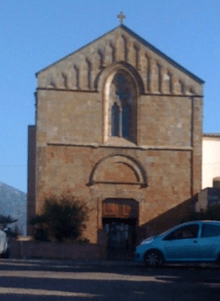 Brick church with a car parked in front