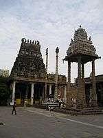 a pyramidal temple tower, with a four pillared dome in its foreground