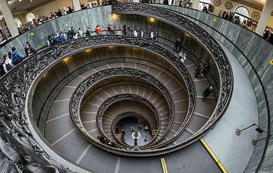 Vast spiral staircase. It is a stepped ramp about 15 meters in diameter, and descends 5 stories at about a 10 degree incline.