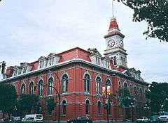 Exterior view of red-brick Victoria City Hall with clock tower