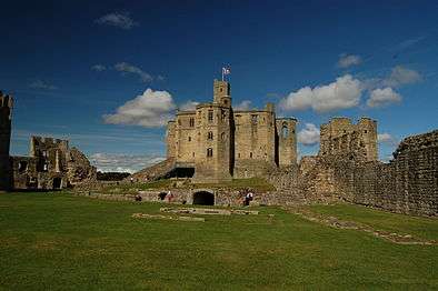 Mostly intact stone tower, with ruined walls on either side